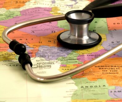 Concept - health care in Africa - map and stethoscope